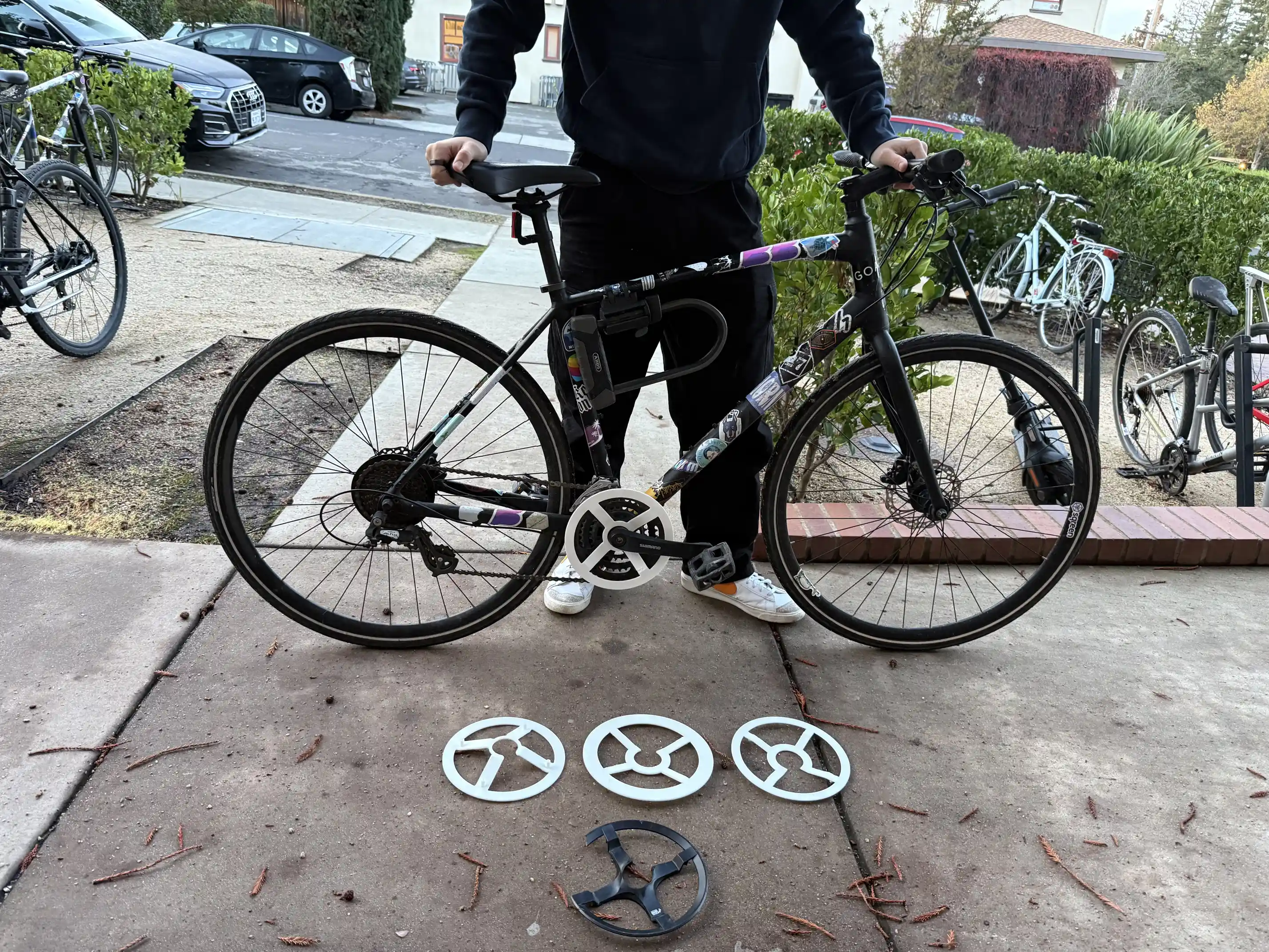 Me posing alongside my bike and an array of 3D-printed parts.