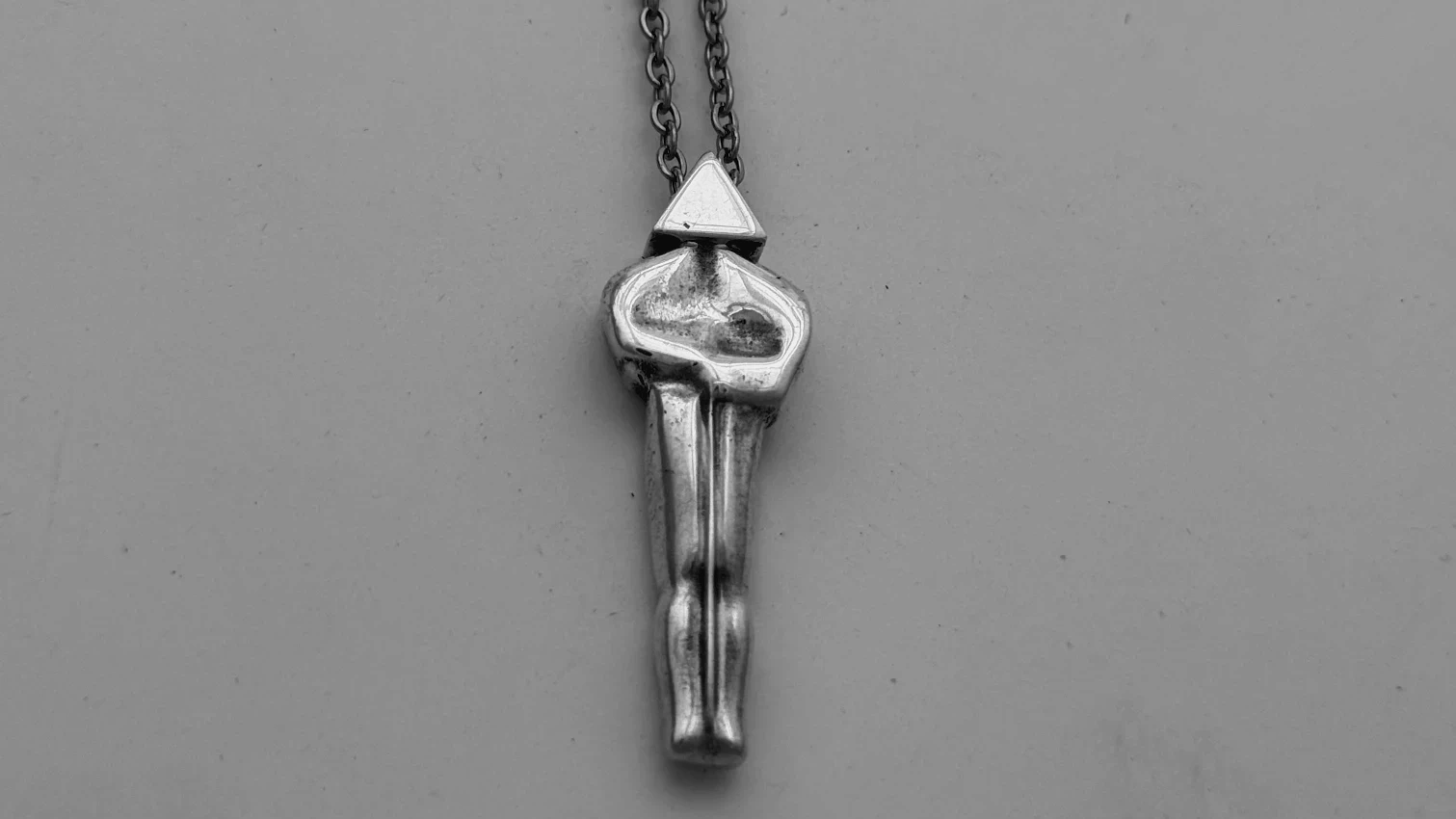 A silver Oscar pendant with my “signature” triangular head motif.